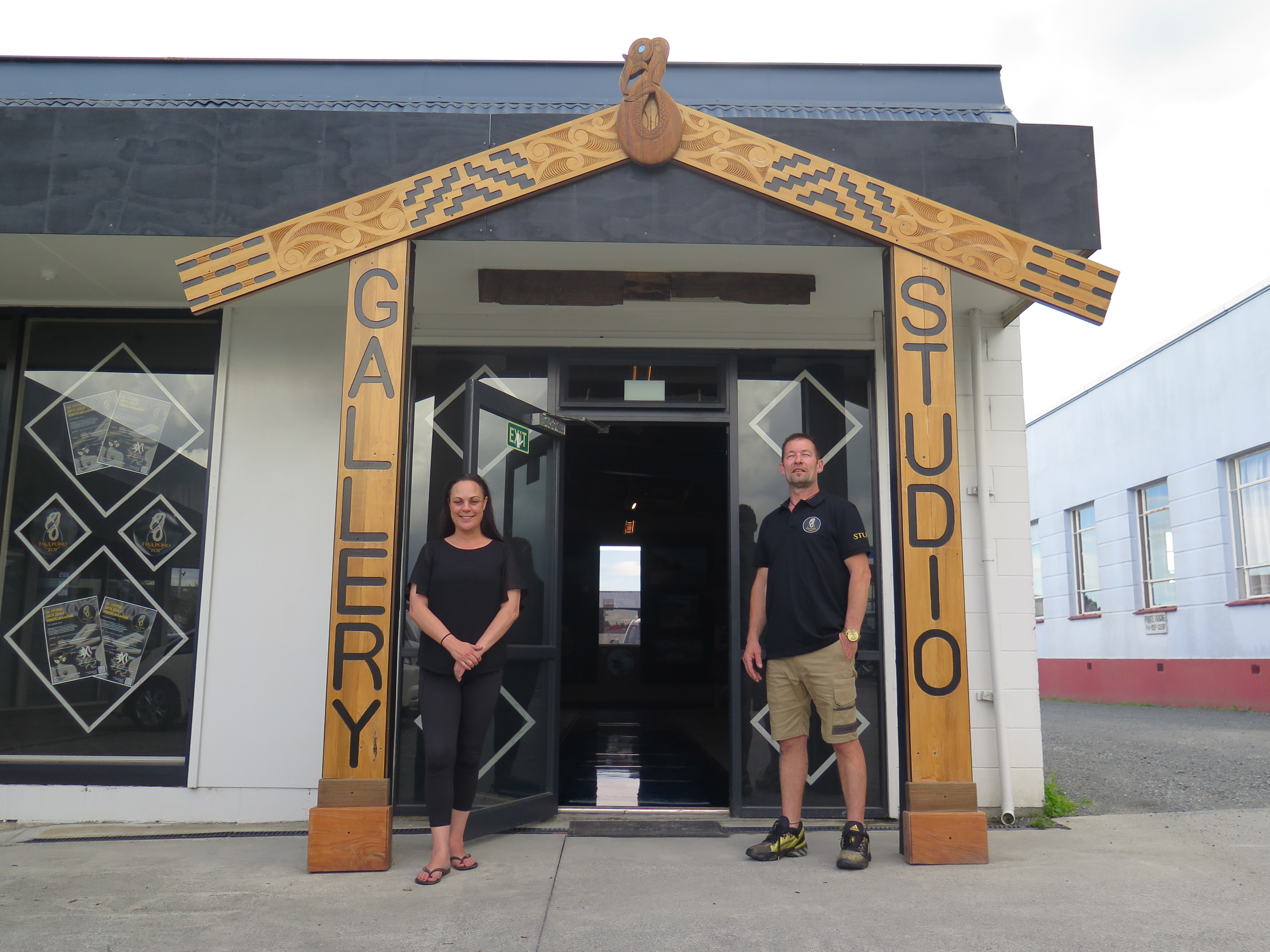 Mark Lang standing outside his gallery with Tracy Robinson, an employee at the gallery